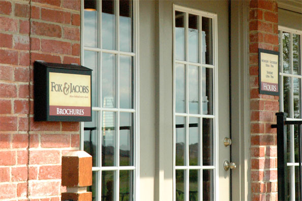 Wall-mounted brochure box on the exterior of a model home