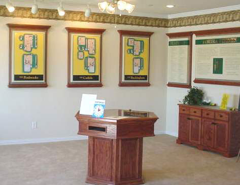 The Portrait Homes showroom with a plat table in the center of the room and floorplans hanging on the walls