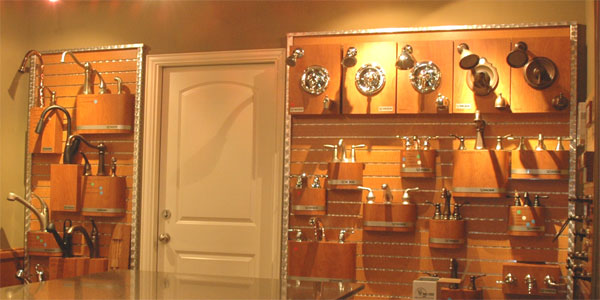 A wall covered in faucet examples in the Landstar Homes showroom