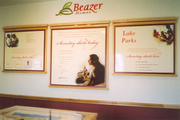 Three framed wall displays in a Beazer Homes sales office