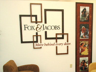 A painted acrylic routed logo with many decorative elements