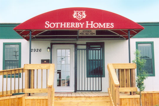 A red awning with an arched top mounted on a trailer