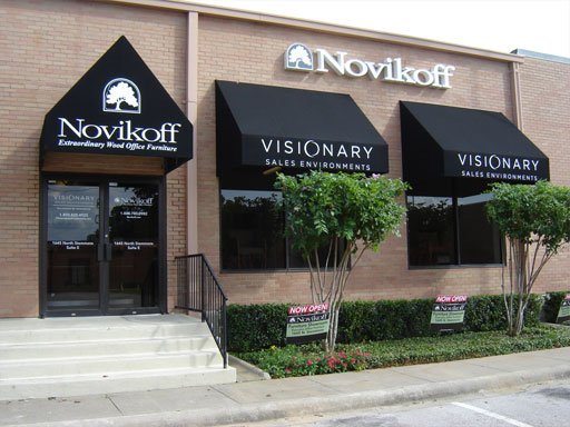 Three black awnings mounted on the front of a showroom