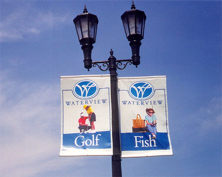 Two banners mounted side-by-side on a light post