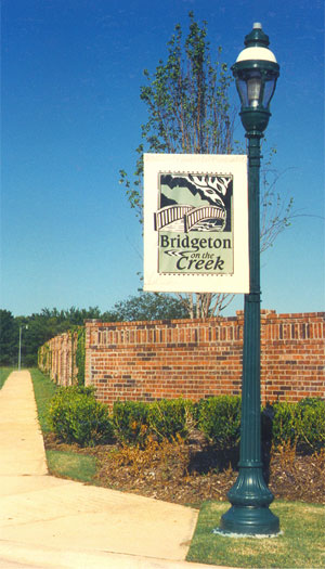 A single banner mounted on a green light post