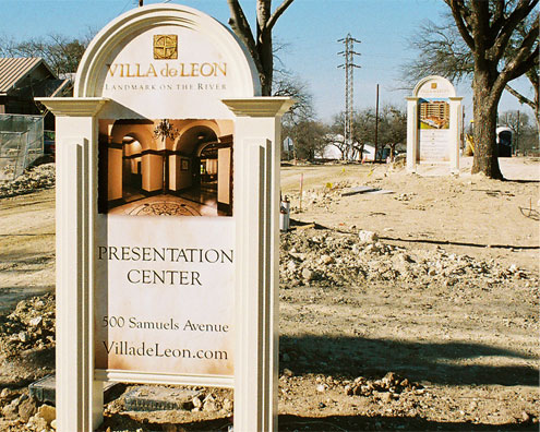 Large signs painted with a textured look at the Villa de Leon development