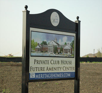 A black sign with an arched top and decorative posts with finial balls