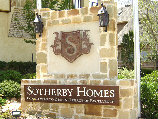 Sotherby Homes monument sign with a rusted steel plate and shield-shaped logo