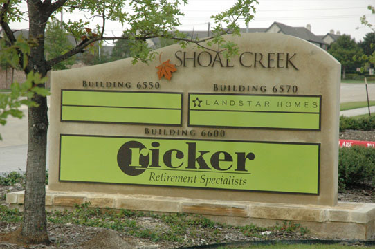 Shoal Creek tenant monument sign with three tenants listed in large green boxes